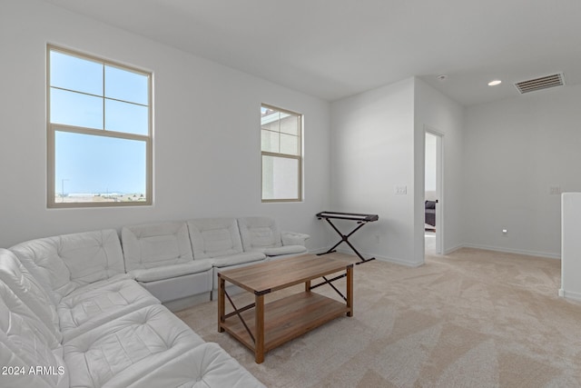 living room featuring light carpet and a wealth of natural light