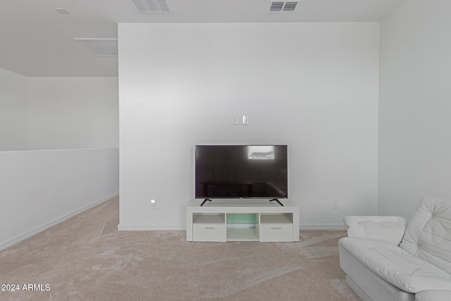 unfurnished living room with light colored carpet