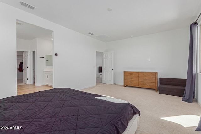 carpeted bedroom featuring ensuite bathroom