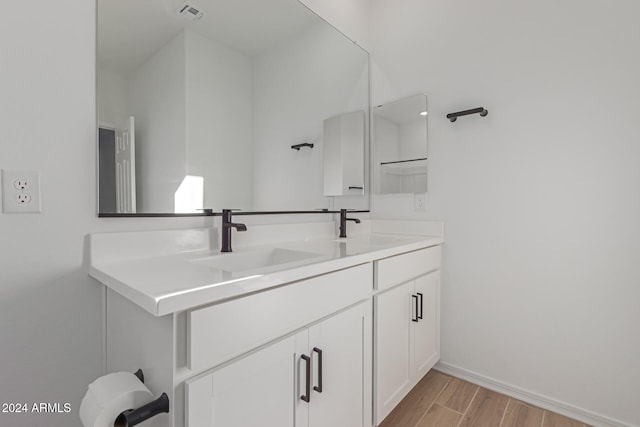 bathroom featuring vanity and hardwood / wood-style flooring