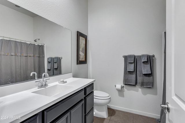 bathroom featuring vanity, toilet, a shower with curtain, and tile patterned floors