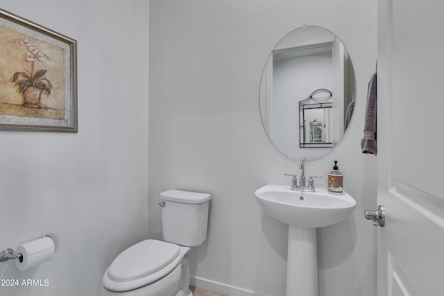 bathroom featuring toilet and sink