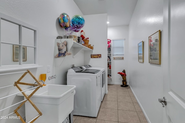 laundry room with washer and dryer, sink, and light tile patterned floors