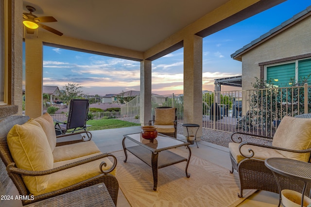 patio terrace at dusk with an outdoor hangout area and ceiling fan