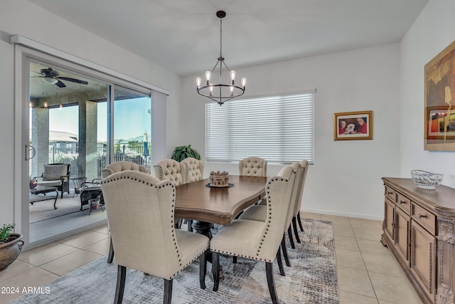 tiled dining space featuring ceiling fan with notable chandelier