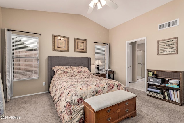 bedroom featuring baseboards, lofted ceiling, visible vents, and light carpet