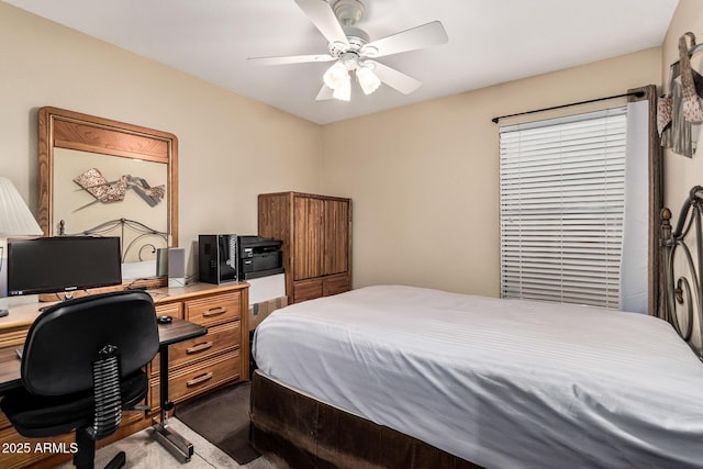 bedroom with dark colored carpet and a ceiling fan