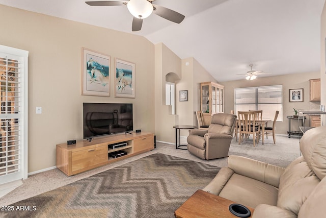 living room featuring carpet flooring, a ceiling fan, and lofted ceiling