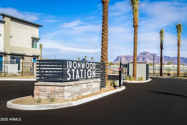 651 N Ironwood Dr Unit 8, Apache Junction, AZ 85120 - view of asphalt street with a mountain view, a gated entry, and curbs