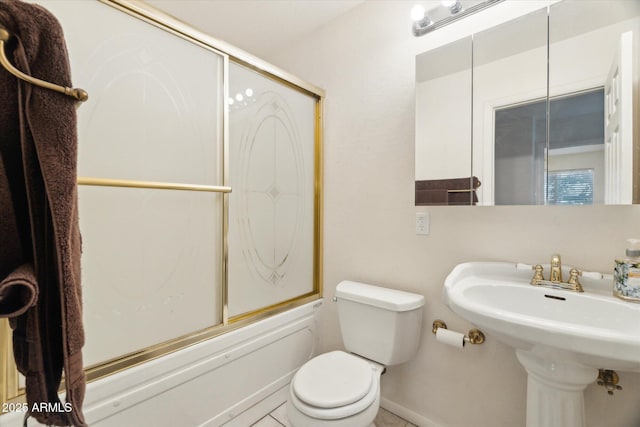 full bathroom featuring combined bath / shower with glass door, sink, and toilet