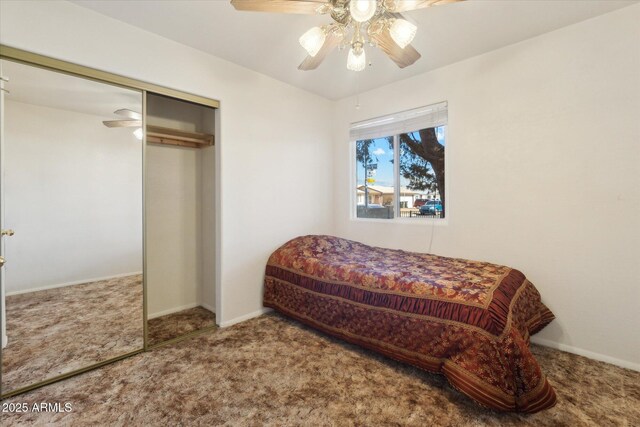 bedroom featuring ceiling fan, a closet, and carpet