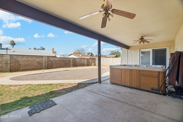 view of patio / terrace featuring a hot tub and ceiling fan