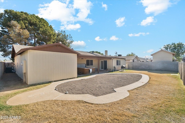 rear view of house featuring a lawn