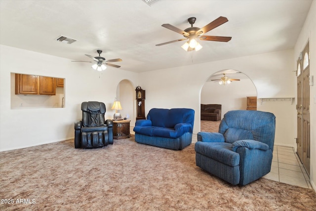 carpeted living room featuring ceiling fan