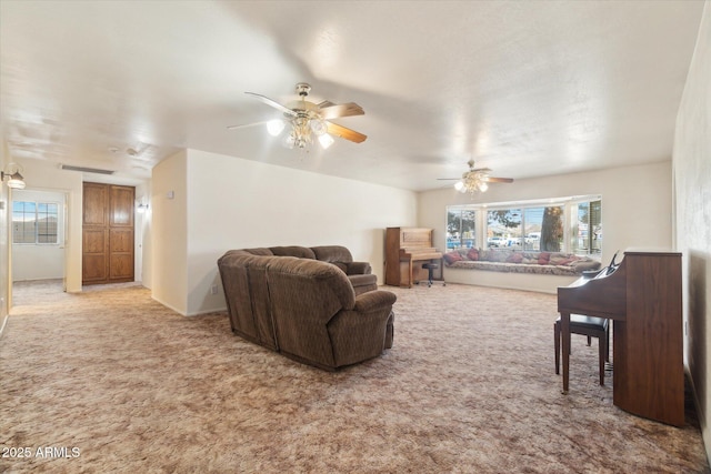 carpeted living room with ceiling fan