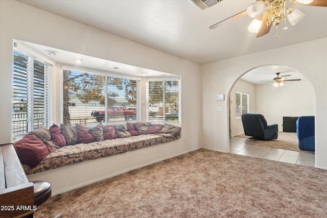 carpeted living room with ceiling fan