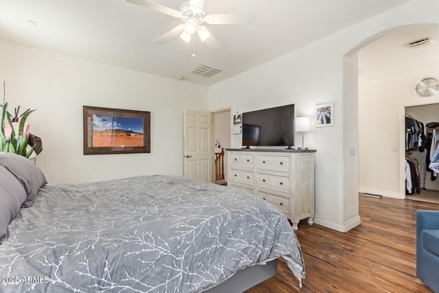 3381 E Canary Way, Chandler, AZ 85286 - bedroom featuring arched walkways, wood finished floors, baseboards, and ceiling fan