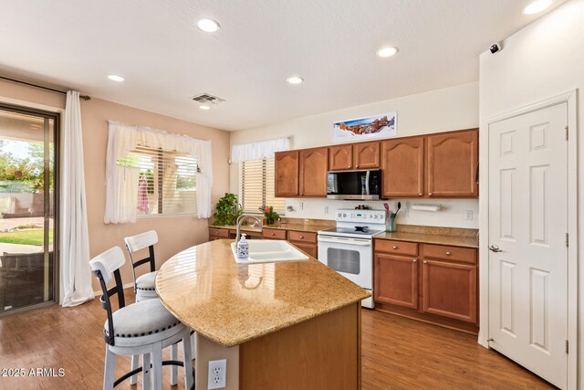 3381 E Canary Way, Chandler, AZ 85286 - kitchen with white electric range oven, a sink, stainless steel microwave, plenty of natural light, and recessed lighting