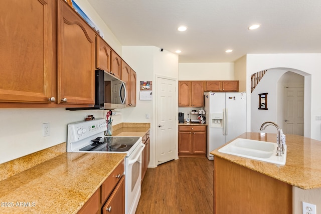 3381 E Canary Way, Chandler, AZ 85286 - kitchen featuring white appliances, a sink, arched walkways, dark wood-style flooring, and recessed lighting