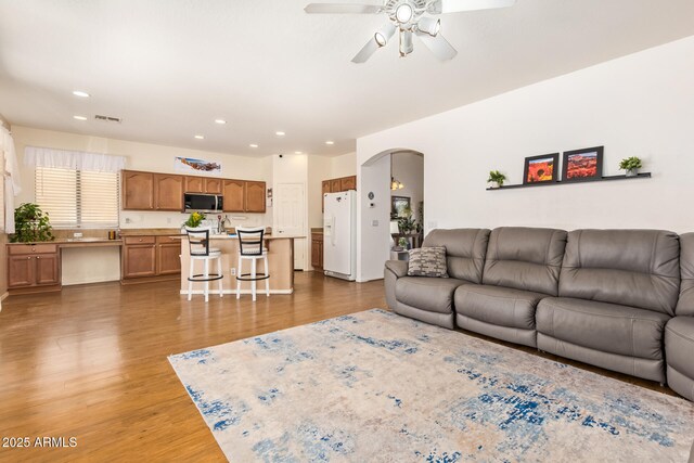3381 E Canary Way, Chandler, AZ 85286 - living area featuring arched walkways, ceiling fan, wood finished floors, and recessed lighting