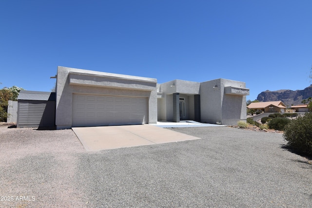 2570 E Manzanita St, Apache Junction, AZ 85119 - view of front of property with an attached garage, driveway, stucco siding, and a mountain view