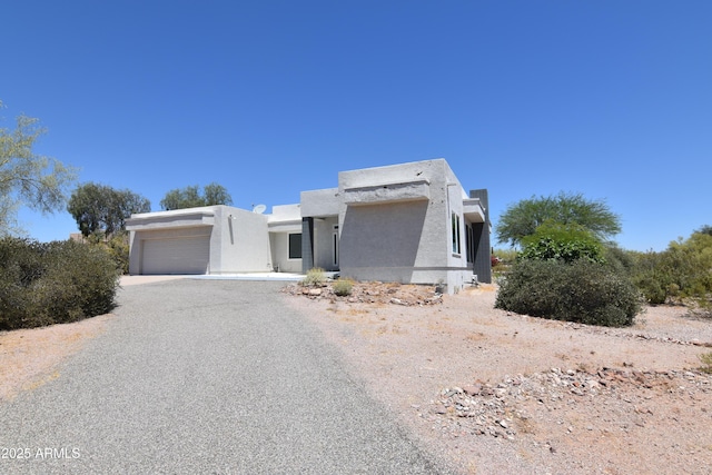 2570 E Manzanita St, Apache Junction, AZ 85119 - view of front facade with stucco siding, a garage, and driveway