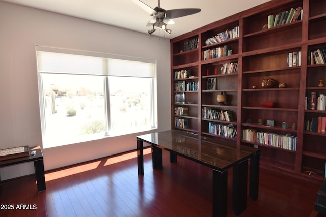 2570 E Manzanita St, Apache Junction, AZ 85119 - home office featuring wall of books, a ceiling fan, and dark wood-type flooring