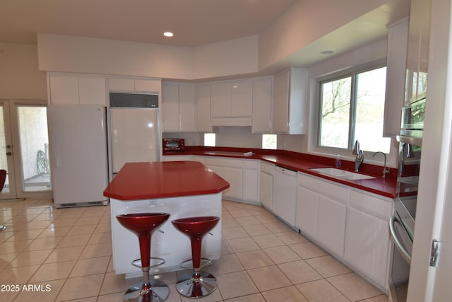 2570 E Manzanita St, Apache Junction, AZ 85119 - kitchen with white appliances, a sink, white cabinets, a center island, and light tile patterned floors