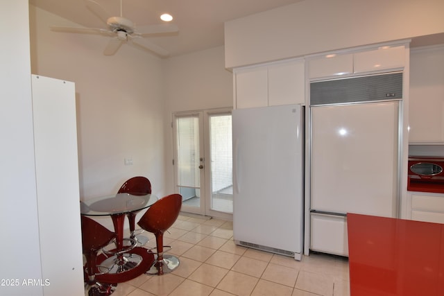 2570 E Manzanita St, Apache Junction, AZ 85119 - kitchen with freestanding refrigerator, paneled built in fridge, light tile patterned floors, white cabinets, and a ceiling fan