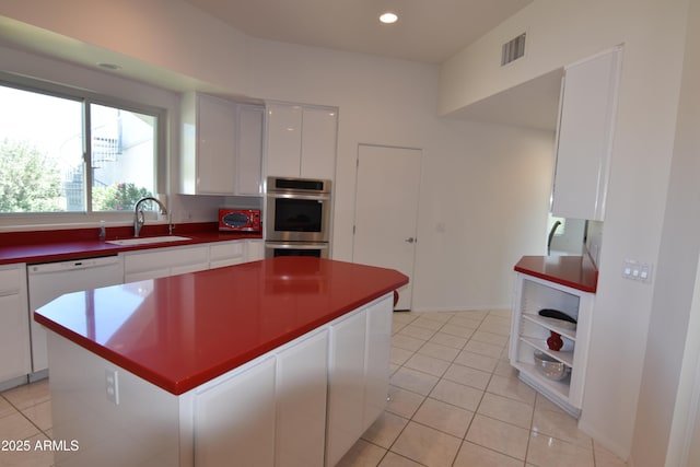 2570 E Manzanita St, Apache Junction, AZ 85119 - kitchen with stainless steel double oven, white dishwasher, white cabinets, a sink, and dark countertops