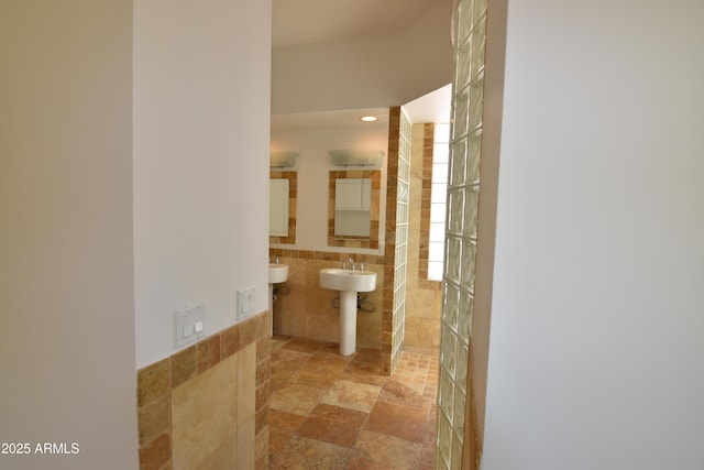 2570 E Manzanita St, Apache Junction, AZ 85119 - bathroom featuring tile walls, tiled shower, stone finish flooring, recessed lighting, and a sink