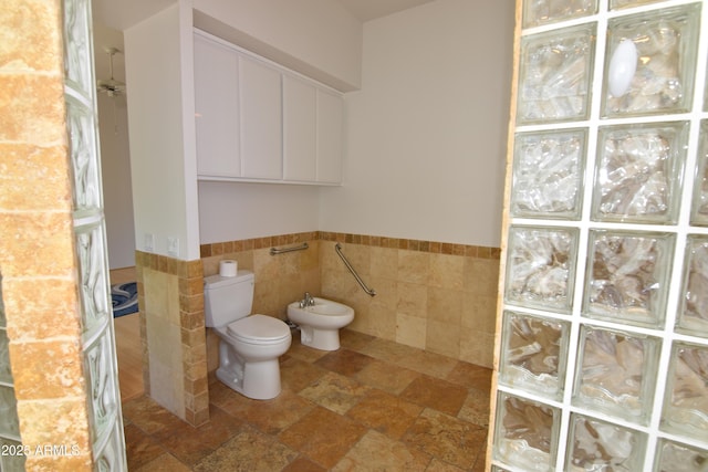 2570 E Manzanita St, Apache Junction, AZ 85119 - bathroom featuring tile walls, a bidet, toilet, a walk in shower, and a wainscoted wall