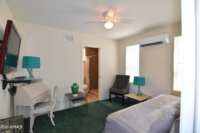 2570 E Manzanita St, Apache Junction, AZ 85119 - carpeted bedroom featuring a wall mounted air conditioner, a ceiling fan, and ensuite bath
