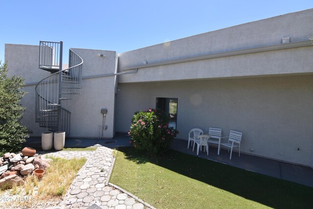 2570 E Manzanita St, Apache Junction, AZ 85119 - back of house with stairs, stucco siding, and a patio