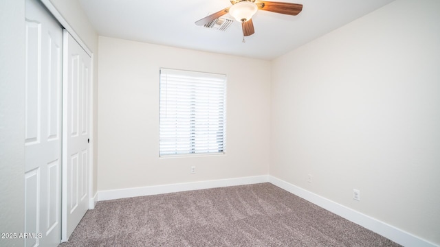 unfurnished bedroom with ceiling fan, a closet, and carpet