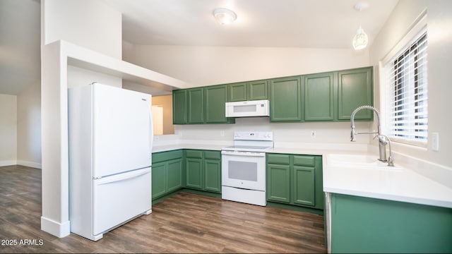 kitchen featuring white appliances, green cabinets, decorative light fixtures, dark hardwood / wood-style flooring, and sink