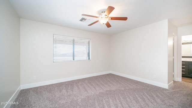 carpeted spare room with ceiling fan