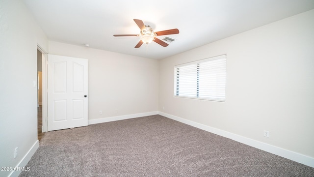 empty room featuring carpet floors and ceiling fan