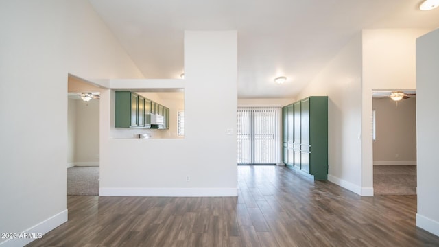 unfurnished living room featuring vaulted ceiling, ceiling fan, and dark hardwood / wood-style floors