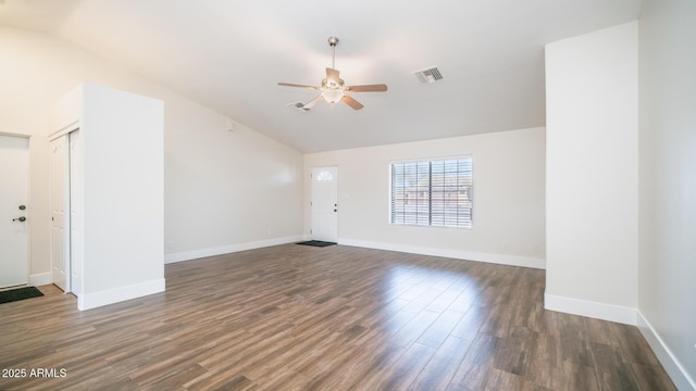 interior space with ceiling fan, vaulted ceiling, and dark hardwood / wood-style floors