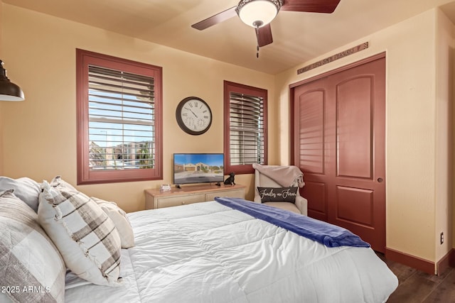 bedroom with ceiling fan and dark wood-type flooring