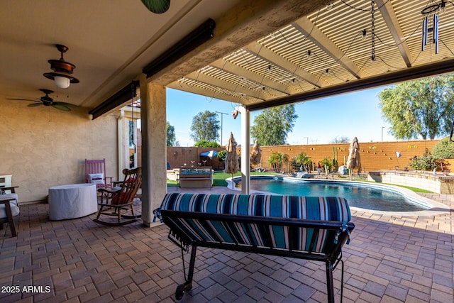 view of patio / terrace featuring ceiling fan, a pergola, and a fenced in pool