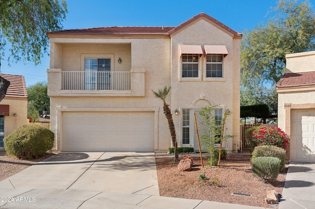 view of front facade featuring a balcony and a garage