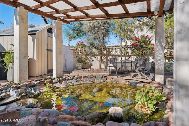 exterior space featuring a small pond and a pergola