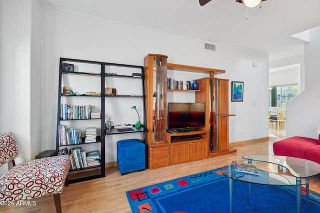 living room with ceiling fan and light hardwood / wood-style floors