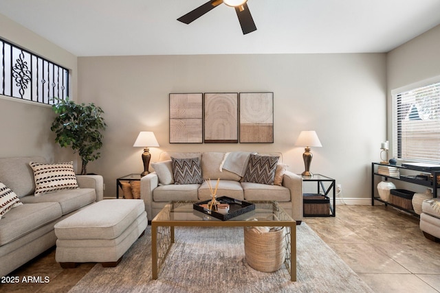 living room featuring ceiling fan and baseboards