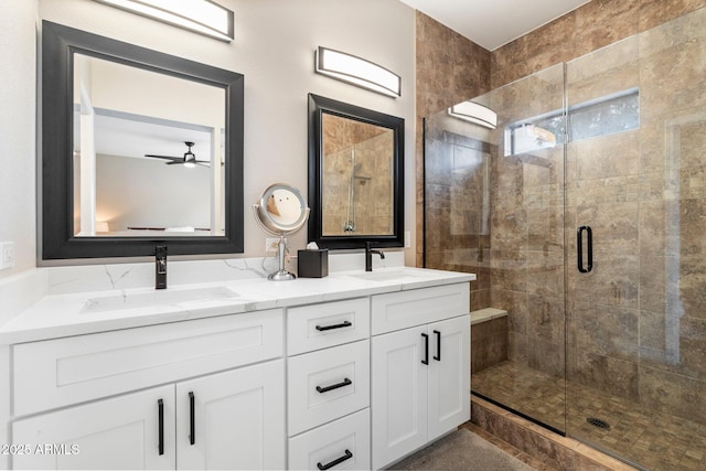 full bathroom featuring double vanity, a stall shower, and a sink