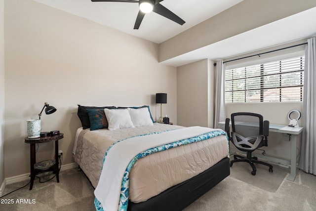 bedroom with light carpet, ceiling fan, and baseboards