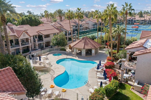 pool featuring a gazebo, a patio area, fence, and a residential view