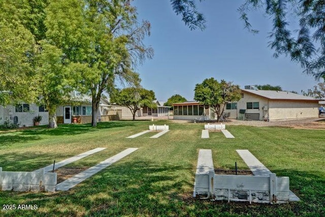 view of home's community with a yard